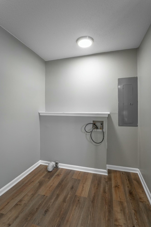 laundry area with electric panel, wood finished floors, baseboards, hookup for a washing machine, and laundry area