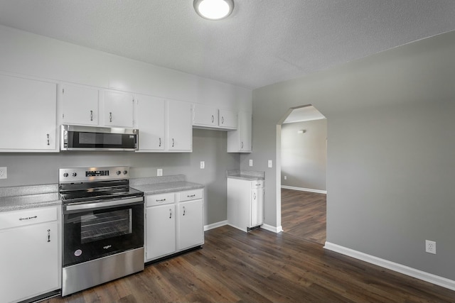 kitchen featuring white cabinets, stainless steel appliances, and light countertops