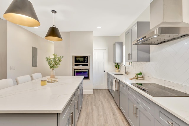 kitchen featuring a sink, black appliances, wall chimney exhaust hood, and gray cabinets