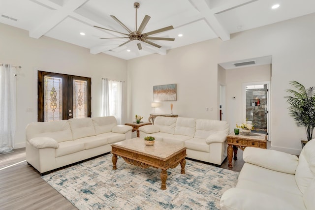 living room featuring wood finished floors, visible vents, coffered ceiling, and ceiling fan