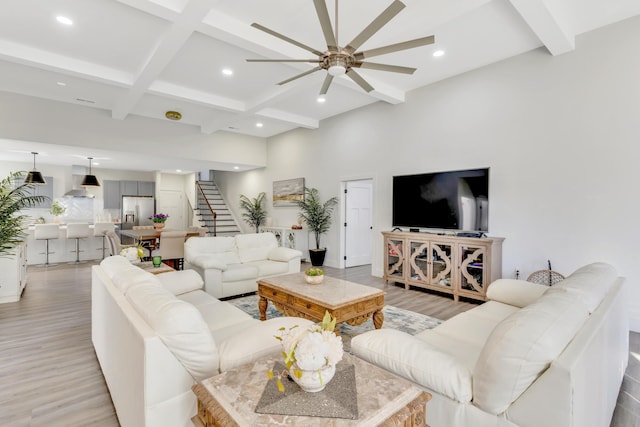 living area with stairway, beam ceiling, recessed lighting, light wood-style flooring, and a ceiling fan