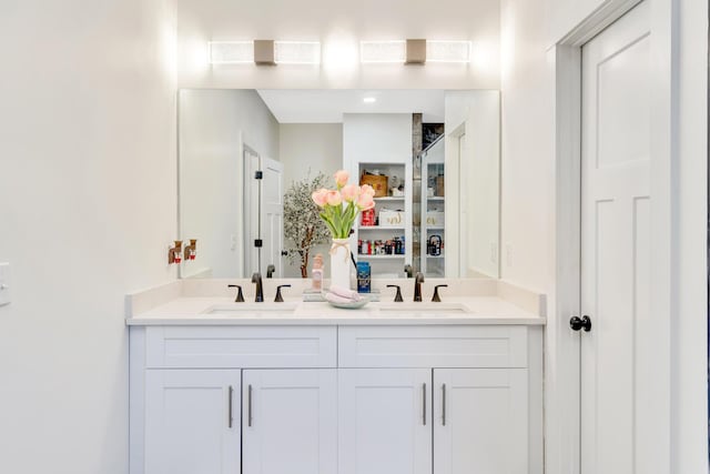 full bath featuring double vanity and a sink