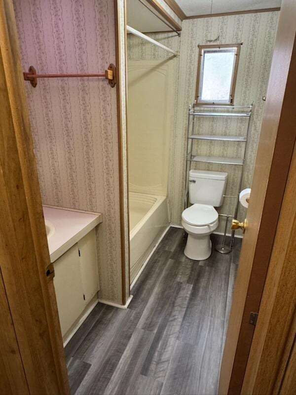 full bath with vanity, toilet, wood finished floors, and tub / shower combination