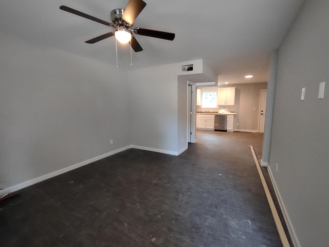 spare room with baseboards and ceiling fan