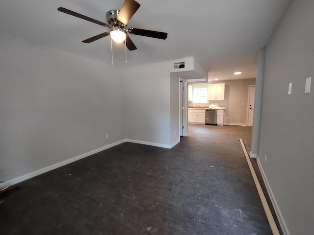 unfurnished room featuring baseboards, concrete floors, and ceiling fan