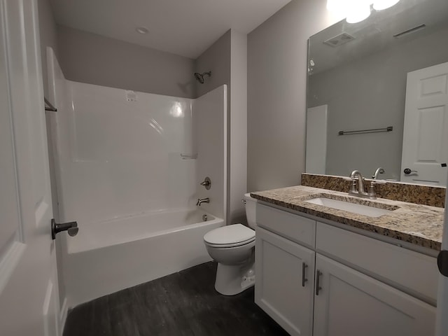 full bath with visible vents, toilet, wood finished floors, tub / shower combination, and vanity