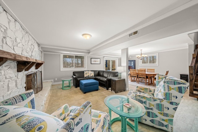 living area featuring a chandelier, visible vents, a stone fireplace, and baseboards