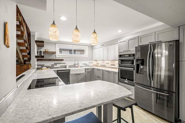 kitchen with a sink, open shelves, gray cabinets, and stainless steel appliances