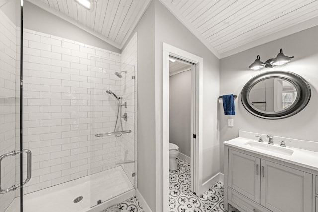 bathroom featuring toilet, a shower stall, baseboards, vanity, and vaulted ceiling