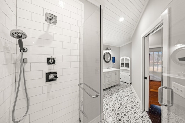 full bath with vanity, tile patterned floors, baseboards, and a stall shower