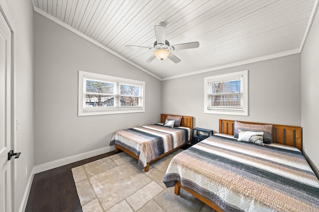 bedroom with crown molding, baseboards, lofted ceiling, wood finished floors, and a ceiling fan