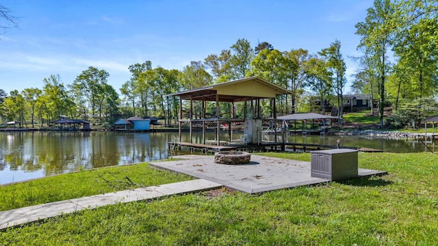 dock area featuring a yard, a water view, and an outdoor fire pit