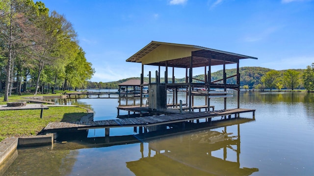 dock area featuring boat lift and a water view