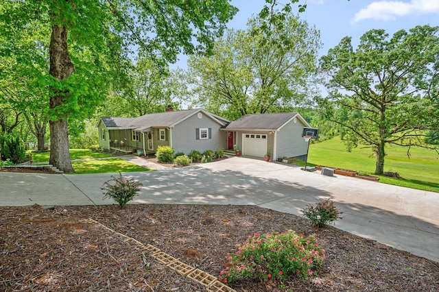 ranch-style home with concrete driveway, a chimney, an attached garage, and a front yard