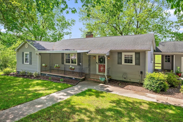 single story home with covered porch, a shingled roof, a chimney, and a front yard