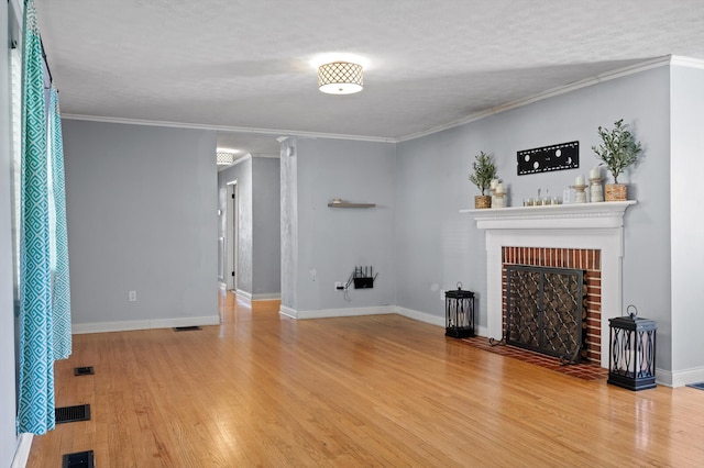unfurnished living room with a fireplace, light wood finished floors, and baseboards