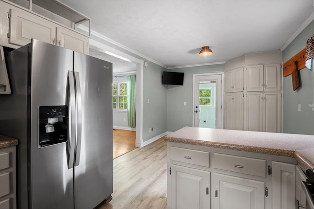 kitchen featuring stainless steel fridge with ice dispenser, light wood-style flooring, crown molding, and white cabinets
