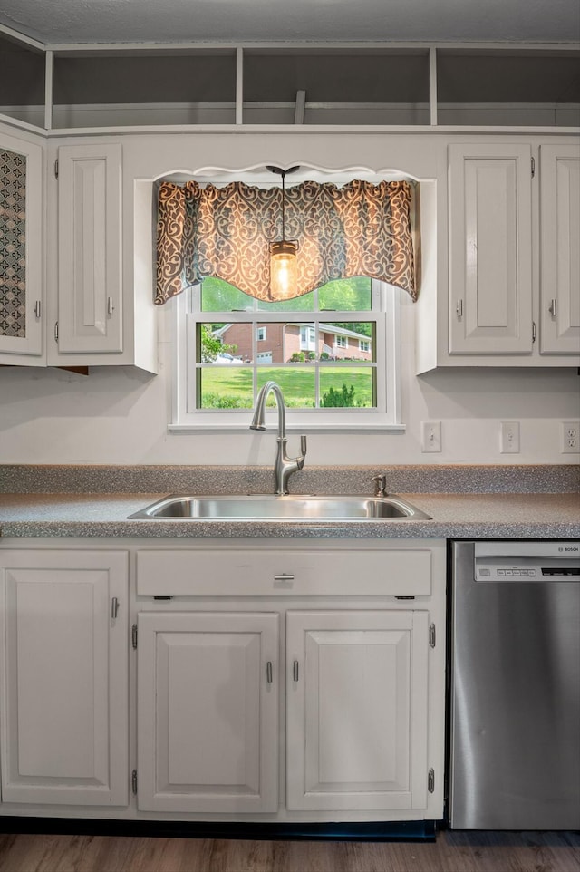 kitchen featuring a sink, stainless steel dishwasher, and white cabinetry