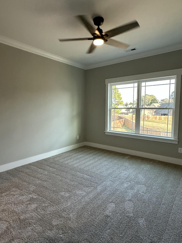 unfurnished room featuring visible vents, ornamental molding, carpet floors, baseboards, and ceiling fan