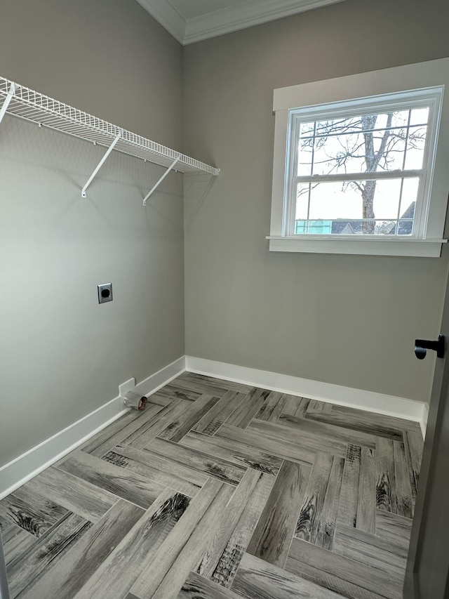 laundry area featuring baseboards, hookup for an electric dryer, laundry area, and crown molding