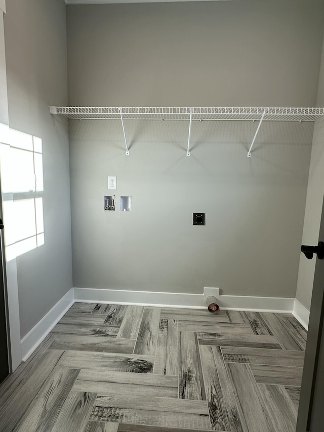 clothes washing area with laundry area, hookup for a washing machine, baseboards, and electric dryer hookup