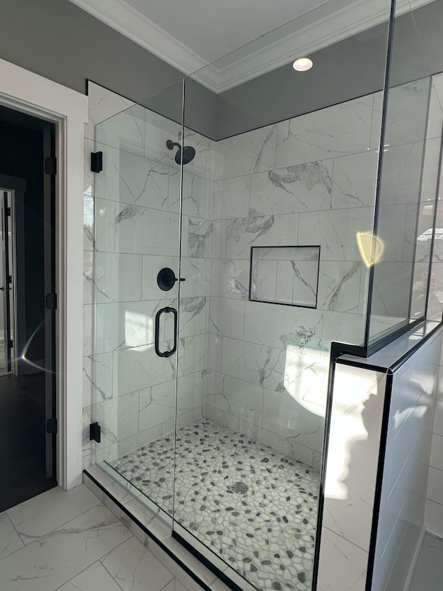 full bathroom featuring marble finish floor, ornamental molding, and a shower stall