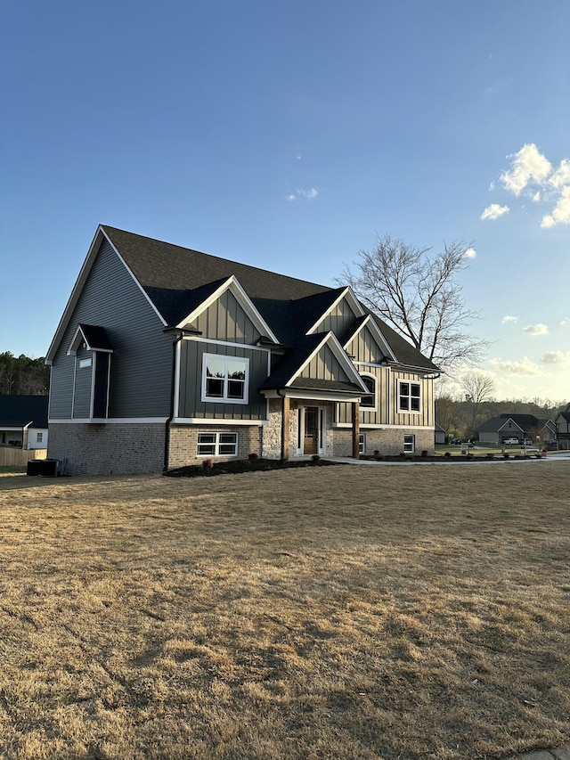 view of front of property with a front lawn and board and batten siding