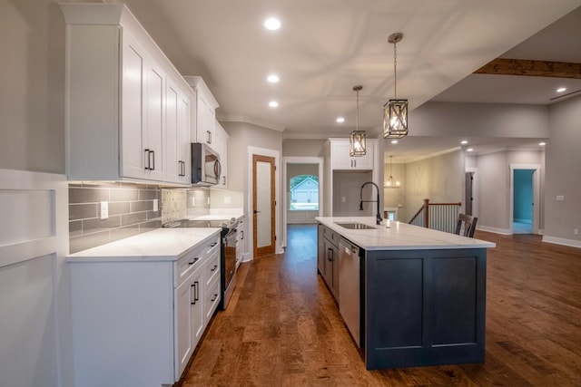 kitchen featuring white cabinetry, dark wood-style flooring, stainless steel appliances, backsplash, and a sink