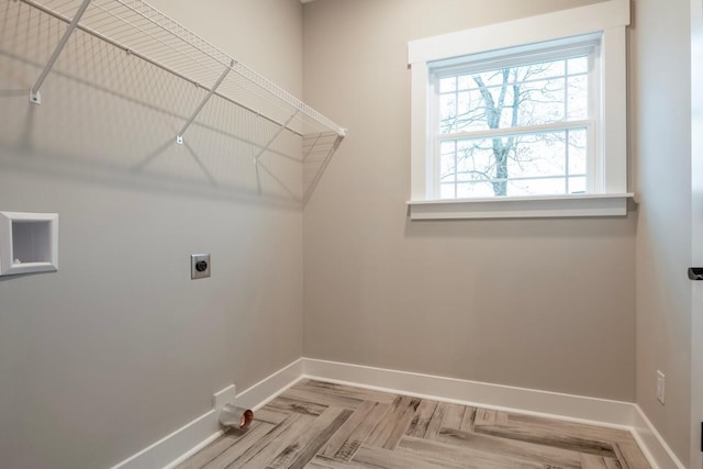washroom featuring baseboards, laundry area, and hookup for an electric dryer