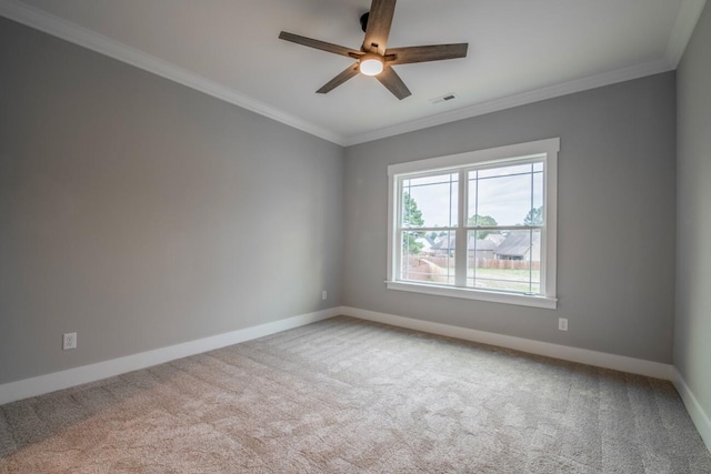 carpeted empty room with baseboards, ornamental molding, visible vents, and ceiling fan
