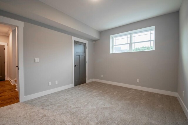 unfurnished bedroom featuring carpet and baseboards