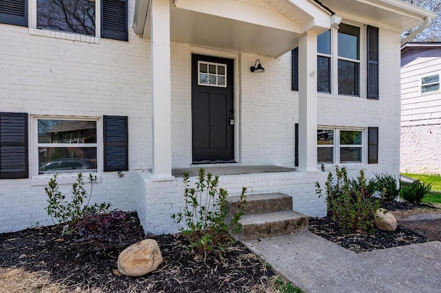property entrance featuring brick siding