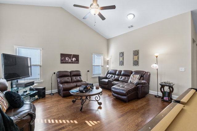 living area with high vaulted ceiling, wood finished floors, visible vents, and ceiling fan