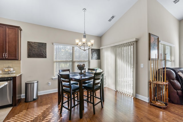 dining room featuring visible vents, baseboards, vaulted ceiling, an inviting chandelier, and dark wood-style flooring