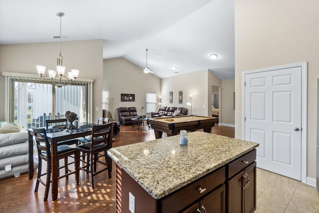 kitchen featuring visible vents, open floor plan, dark brown cabinetry, pool table, and hanging light fixtures