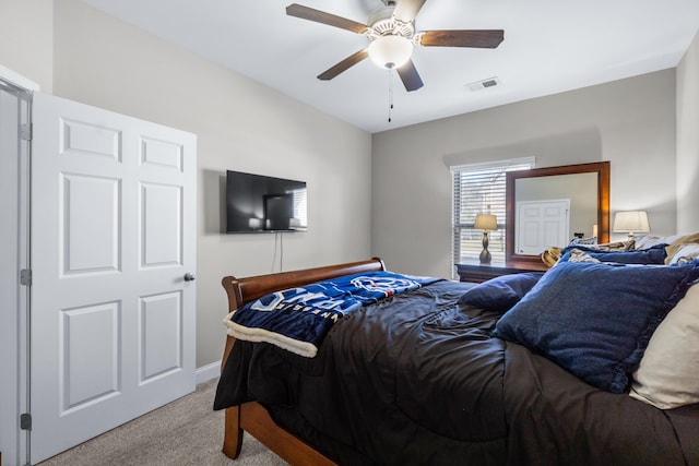 bedroom with light colored carpet, visible vents, and ceiling fan