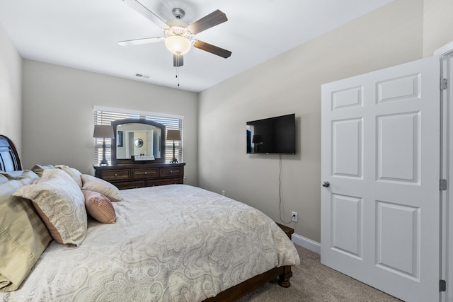 carpeted bedroom featuring baseboards, visible vents, and ceiling fan