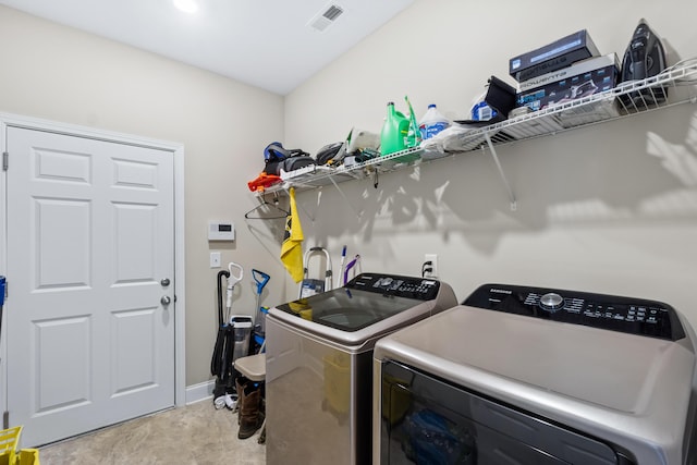 laundry area featuring laundry area, washing machine and dryer, visible vents, and baseboards