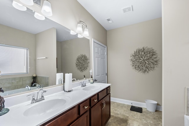 full bathroom featuring double vanity, visible vents, and a sink