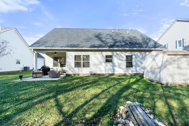 back of property with ceiling fan, a shed, central air condition unit, an outdoor structure, and a patio area