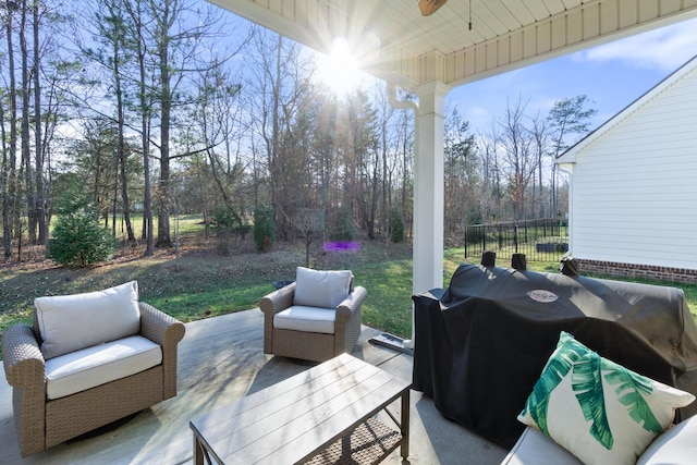 view of patio with area for grilling, an outdoor living space, a ceiling fan, and fence