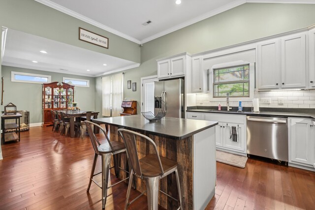 524 Ladd Ave, Chattanooga, TN 37405 - kitchen with dark countertops, crown molding, decorative backsplash, appliances with stainless steel finishes, and a sink