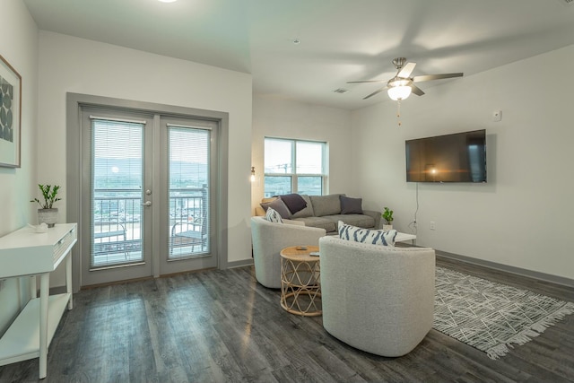 living area featuring french doors, baseboards, ceiling fan, and wood finished floors