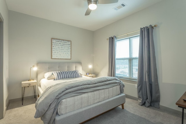 bedroom featuring visible vents, baseboards, and light colored carpet