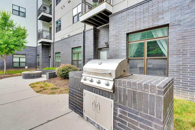 view of patio with a grill and an outdoor kitchen