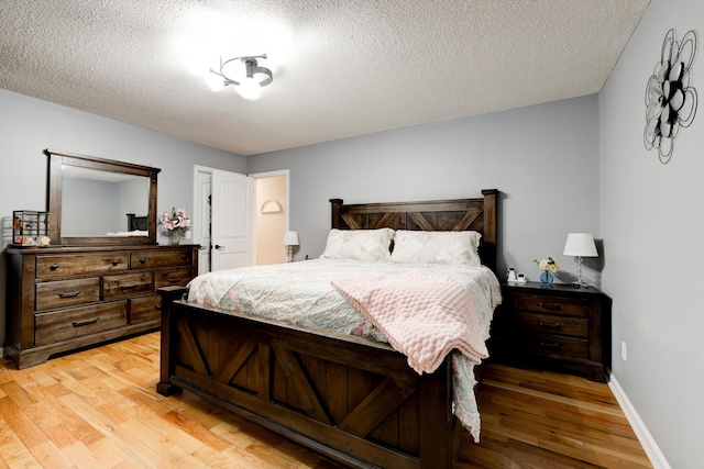 186 Joann Dr SE, Calhoun, GA 30701 - bedroom featuring light wood-style floors, baseboards, and a textured ceiling