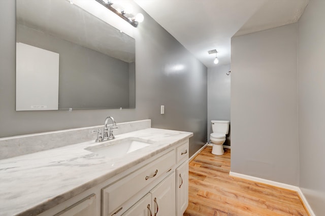 186 Joann Dr SE, Calhoun, GA 30701 - bathroom with toilet, vanity, baseboards, and wood finished floors