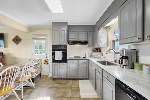 kitchen with gray cabinetry, black appliances, under cabinet range hood, and a sink