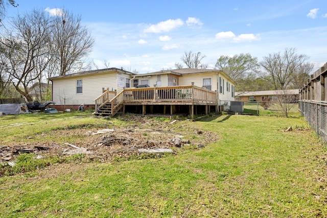 rear view of house with a fenced backyard, a lawn, a deck, and central air condition unit