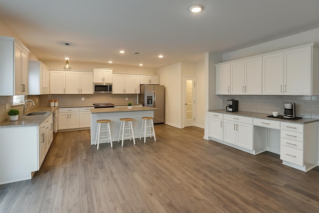 254 Shoreline Trce, Fort Oglethorpe, GA 30742 - kitchen featuring white cabinetry, a sink, backsplash, and appliances with stainless steel finishes